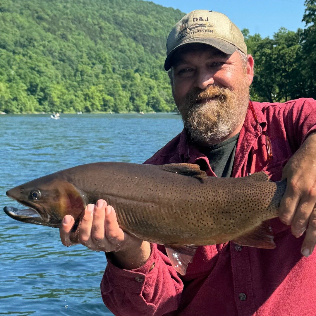 A working guide boat on open water, photographed by Wandering Fly Outfitters in AR