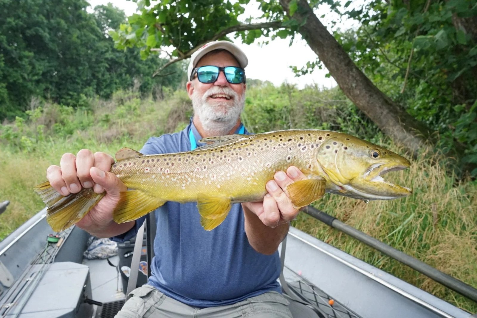 A guide working with a client on the water, photographed by Woodard Fly Fishing in AR